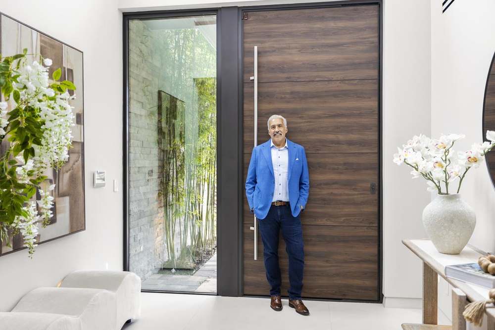 Carlos A. Calderon at the front door of a residence